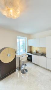 a kitchen with a table and a chair in it at Monaco 2bdr luxury apartment, private garden&pool in Beausoleil