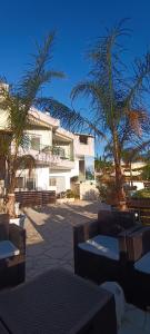 a building with palm trees in front of a building at Villa Nefeli Ksamil in Ksamil