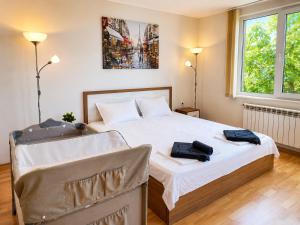 a bedroom with a bed with two bags on it at Villa Avelia - Sea View Jacuzzi Retreat in Varna City
