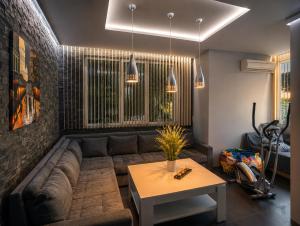 a living room with a couch and a table at Villa Avelia - Sea View Jacuzzi Retreat in Varna City