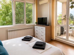a bedroom with a bed with two towels on it at Villa Avelia - Sea View Jacuzzi Retreat in Varna City