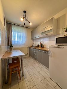 a kitchen with a white refrigerator and a table at Dunajecki Zakątek z Jacuzzi in Biały Dunajec +32 photos