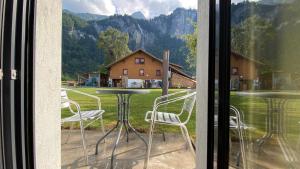 a view of a table and chairs from a window at Falke-Apart 1 am Wasserfall in Unterbach