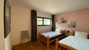 a bedroom with two beds and a window at Falke-Apart 1 am Wasserfall in Unterbach