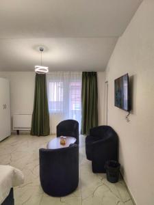 a living room with two chairs and a table at Golden Guesthouse in Resen +52 photos