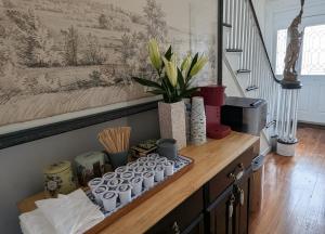 a wooden shelf with cups and a potted plant on it at Sullivan Heritage 1847 - Queen Room Private Bathroom in A Private Home in Boston