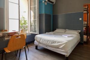 a bedroom with a bed and a blue wall at Simple Stay - Fresh Start May 2026 in Nice