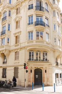 a tall building with a man standing in front of it at Simple Stay - Fresh Start May 2026 in Nice