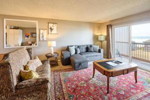 a living room with a couch and a table at Ground Floor - Ocean View Condo - Pet-Friendly in Lincoln City