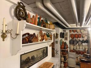 a room filled with lots of vases and a fireplace at Maison Mosgenstein in Bern +25 photos