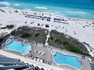 an aerial view of a beach with two swimming pools at 2 BR Oceanfront Condo with Shared Pool & Hot Tub in Panama City Beach