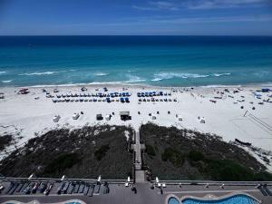 an aerial view of a beach with umbrellas and the ocean at 2 BR Oceanfront Condo with Shared Pool & Hot Tub in Panama City Beach