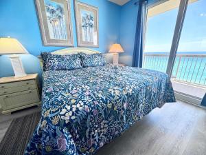 a blue bedroom with a bed and a window at 2 BR Oceanfront Condo with Shared Pool & Hot Tub in Panama City Beach +13 photos