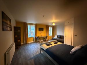 a bedroom with a bed and a couch at Bar 21 in Hunstanton