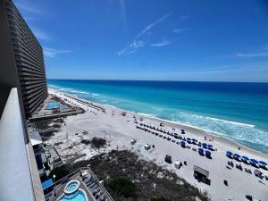 a view of a beach with umbrellas and the ocean at 2 BR Oceanfront Condo with Shared Pool & Hot Tub in Panama City Beach