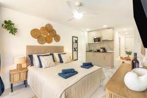 a bedroom with a large bed with blue pillows on it at Ocean Aura Tenerife in Costa de Adeje +23 photos
