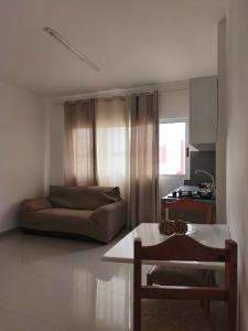 a living room with a couch and a table at Ap Doce Lar in Espargos