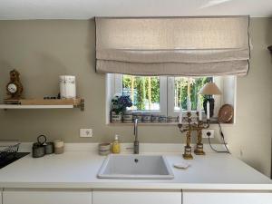 a kitchen counter with a sink and a window at La Casetta in riva al mare in Quercianella