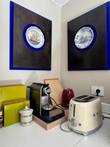 a kitchen with a coffee maker and a toaster on a counter at La Casetta in riva al mare in Quercianella