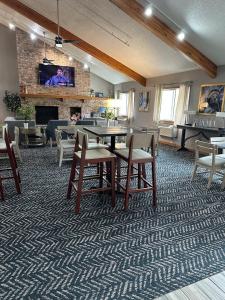 a living room with a table and chairs and a fireplace at AmericInn by Wyndham Red Wing in Red Wing
