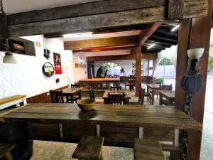 a dining room with a large wooden table and chairs at HAUS EDELWEISS, Casa Quinta en Monte Grande, Bs As, EZEIZA AIRPORT, GARDEN, SWIMMING POOL in Monte Grande