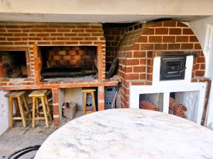 a brick oven with a table in front of it at HAUS EDELWEISS, Casa Quinta en Monte Grande, Bs As, EZEIZA AIRPORT, GARDEN, SWIMMING POOL in Monte Grande