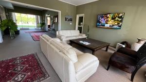 a living room with a white couch and a table at Mercedes Rambla Hotel in Mercedes
