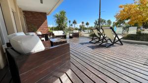 a deck with chairs and furniture on a house at Mercedes Rambla Hotel in Mercedes