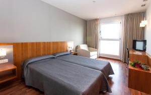 Postel nebo postele na pokoji v ubytování Hotel AG Express Elche