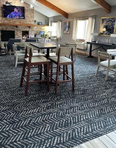 a dining room with a table and chairs and a fireplace at AmericInn by Wyndham Red Wing in Red Wing