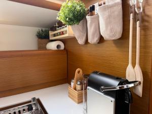 a kitchen with utensils hanging on a wall at ΡΕΝΤ ΜΕ ΟΥΤ Σιμπα in Kavála