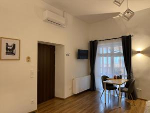 a room with a table and chairs and a window at Apartamenty Stare Podwórko in Pilica
