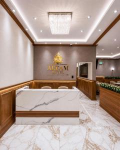 an office with a reception desk and a sign that reads african hotel at Hotel Arkam in San Salvador