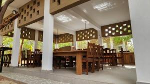 a pavilion with a wooden table and chairs at Suñu Tool Private Farm Guesthouse in Sindia