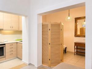 a kitchen with a wooden closet in a room at Milky house Vrachati in Vrachati