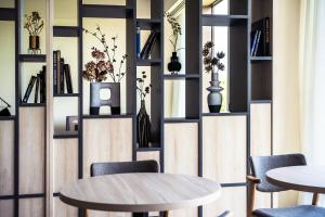 a room with two tables and chairs and shelves at ANA Holiday Inn Kobe Sanda by IHG in Sanda +36 photos