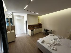 a room with a bed and a table in it at The Bearded Dad Hostel in Tirana
