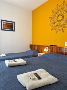 a room with two beds with towels on them at Hostería Altea in Monte Hermoso