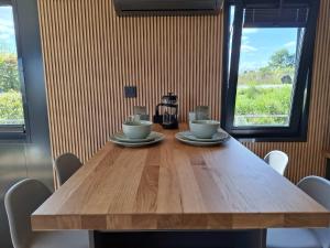 a wooden table with two cups and a coffee maker on it at Aquastay Drift in Athlone +18 photos