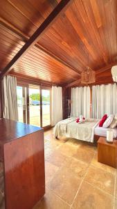 a bedroom with a bed with a wooden ceiling at Casa boa vida in Jericoacoara +77 photos