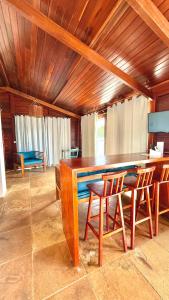 a dining room with a large wooden table and chairs at Casa boa vida in Jericoacoara