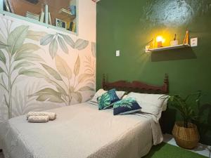 a bedroom with a bed with blue pillows on it at Quarto confortável no Centro- Wi-Fi rápido, ar-condicionado in São Luís
