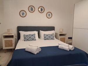 a bedroom with a bed with three clocks on the wall at Casa Lucia in Calabernardo