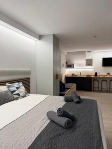 a bedroom with a large bed with two towels on it at Sorolla Urban Suites in Valencia