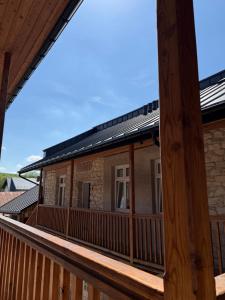 a house with a solarium on the deck at Apartamenty Stare Podwórko in Pilica