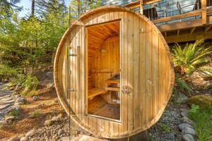 a wooden sauna with a large wooden circle around it at Riverfront retreat with panoramic river and forest views in Rhododendron