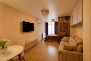 a living room with a couch and a table at Nautilus Apartment in Batumi