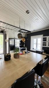 a large wooden table in a kitchen with chairs at La Suite du Havre in Saint-Charles-des-Grondines