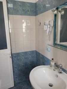 a bathroom with a sink and a shower at RAHI Rooms in Gjilek