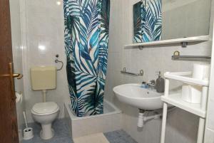 a bathroom with a toilet and a sink at Blagdan Holiday in Kukljica +12 photos